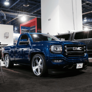 Shiny blue GMC pickup truck in a garage