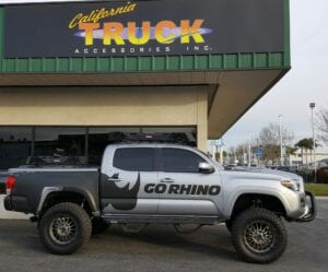 Silver pickup truck with a Go Rhino sticker