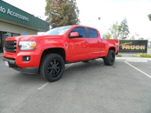 Side view of a bright red pickup truck