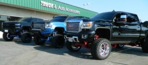 Side view of three pickup trucks parked together