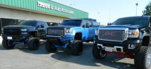 Three pickup trucks parked side by side