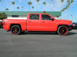 Side view of a bright red pickup truck