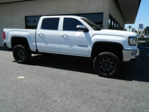 Suspension-lifted white pickup truck