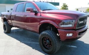 Custom-lifted maroon pickup truck