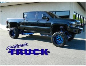 Black pickup truck with blue wheels