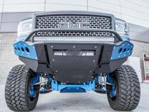 Blue GMC truck with suspension lifts